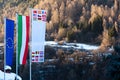 The flag of European Union, Italy and other countries are developing against the backdrop of Dolomites in the spring Royalty Free Stock Photo