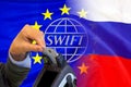 Flag of European Union and Russia flag and logo SWIFT. Sanctions concept