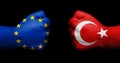 Flag of European Union and Turkey painted on two clenched fists