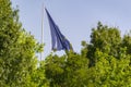 Flag of the European Union waving on a flagpole in a park in the city of Madrid, in Spain. Europe. Royalty Free Stock Photo