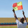 Flag, foul and man soccer referee in football match or game wave to stop play during sport training or workout. Hand