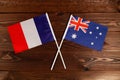 Flag of France and flag of Australia crossed with each other. The image illustrates the relationship between countries