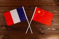 Flag of France and flag of China crossed with each other. The image illustrates the relationship between countries