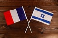 Flag of France and flag of Israel crossed with each other. The image illustrates the relationship between countries