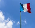 French flag against blue cloudy sky Royalty Free Stock Photo