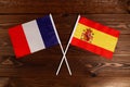 Flag of France and flag of Spain crossed with each other. The image illustrates the relationship between countries