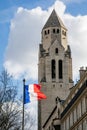The flag of France in front of Saint Pierre of Chaillot Catholic Church in Paris, France Royalty Free Stock Photo