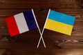 Flag of France and flag of Ukraine crossed with each other. The image illustrates the relationship between countries
