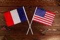 Flag of France and flag of USA crossed with each other. The image illustrates the relationship between countries