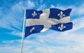 flag of French ancestry Quebecois people at cloudy sky background, panoramic view. flag representing extinct country,ethnic group