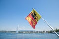 Flag of the Geneva Canton in the city center of Geneva, on the Leman lake. The iconic Jet d`Eau Water Jet can be seen