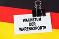 On the flag of Germany lies a business card with the inscription - growth in exports of goods