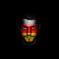 Flag of Germany painted on a face of a man. Royalty Free Stock Photo