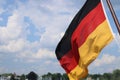 Flag of Germany waving in the wind on the wooden flagpole. German national flag on a a boat. Isolated on the Royalty Free Stock Photo