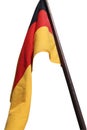 Flag of Germany waving in the wind on the wooden flagpole. German national flag made of silky fabric Royalty Free Stock Photo