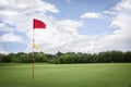 Flag on golf fairway with copyspace. Royalty Free Stock Photo