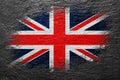 Flag of Great Britain. UK flag is painted on a stone surface. Stone background. Black slate background Royalty Free Stock Photo