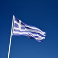 The flag of Greece. Flying in the wind against the blue sky. Corfu Island - Greece. Concept for summer holidays and vacation Royalty Free Stock Photo