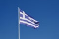 The flag of Greece. Flying in the wind against the blue sky. Corfu Island - Greece. Concept for summer holidays and vacation Royalty Free Stock Photo