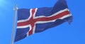 Flag of Iceland waving at wind with blue sky in slow, loop