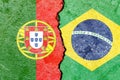 Flag icon of Portugal and Brazil on weathered cracked concrete wall - politics conflicts concept Royalty Free Stock Photo