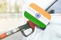 Flag of India on the car`s fuel filler flap with gas pump nozzle in the tank Royalty Free Stock Photo