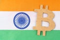 The flag of India has a bitcoin symbol cut out of cardboard. Royalty Free Stock Photo