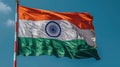 Flag of India waving in the wind against blue sky