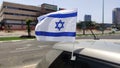 Flag of Israel waving in the wind on a car in honor of Yom Haatzmaut -Israeli Independence Day. Israeli Flag - main symbol