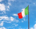 Flag of Italy against the cloudy blue sky Royalty Free Stock Photo