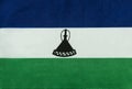 Flag of the Kingdom of Lesotho on a textile basis close up