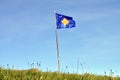 The flag of Kosovo has a blue background, charged with a map of Kosovo and six stars. Royalty Free Stock Photo