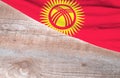 Flag Kyrgyzstan and space for text on a wooden background