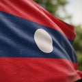 Flag of Laos features three horizontal stripes: red on the top and bottom and blue in Royalty Free Stock Photo
