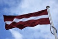 Flag of Latvia flying in breeze Royalty Free Stock Photo