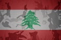 flag of lebanon on the khaki texture . military concept