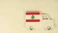 Flag of Lebanon on the recycled cardboad truck icon, national sustainable logistics concept