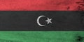 Flag of Libya on wooden plate background. Grunge Libyan flag texture.