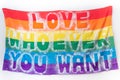 A Flag of love to anyone you want text, Fabric texture of the Gay LGBTQ flag in rainbow colors background