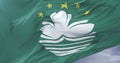 Flag of Macau waving at wind with blue sky in slow, loop
