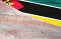 Flag Mozambique and space for text on a wooden background