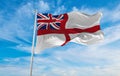 flag of Naval Ensign of the United Kingdom at cloudy sky background on sunset, panoramic view. united kingdom of great Britain,