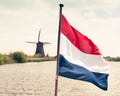 Flag of the Netherlands against windmill background Royalty Free Stock Photo