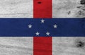 Flag of Netherlands Antilles on wooden plate background. Grunge Netherlands Antilles flag texture.