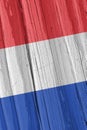 The flag of the Netherlands on dry wooden surface, cracked with age. Vertical background, wallpaper or backdrop with Dutch Royalty Free Stock Photo