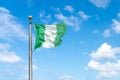 Flag of Nigeria on a background blue sky