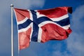 Flag of Norway against a blue sky. Royalty Free Stock Photo