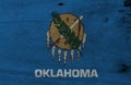 Flag of Oklahoma on wooden plate background. Grunge Oklahoma flag texture, The states of America.