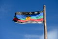 Flag of the original Mapuche people in blue sky