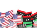 Flag pins of USA and Libya on white